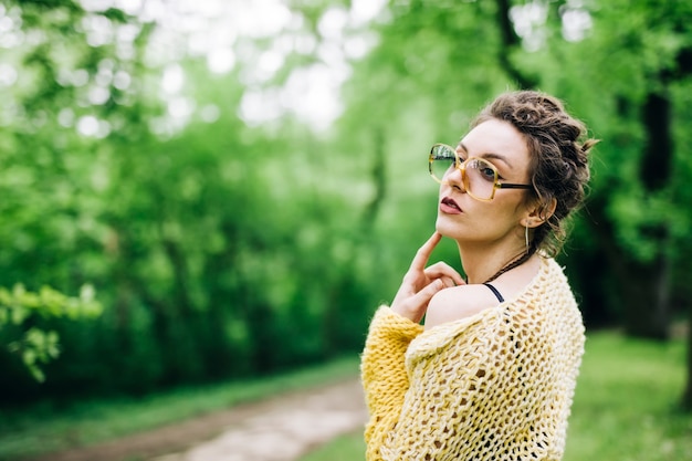 Portret van vrij jonge vrouw met een bril in het park