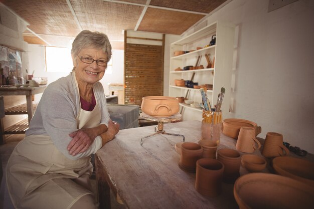 Portret van vrouwelijke pottenbakkerszitting bij lijst