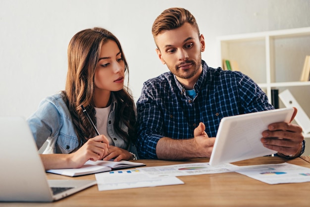 Portret van zakelijke collega's die samen deelnemen aan webinar op kantoor