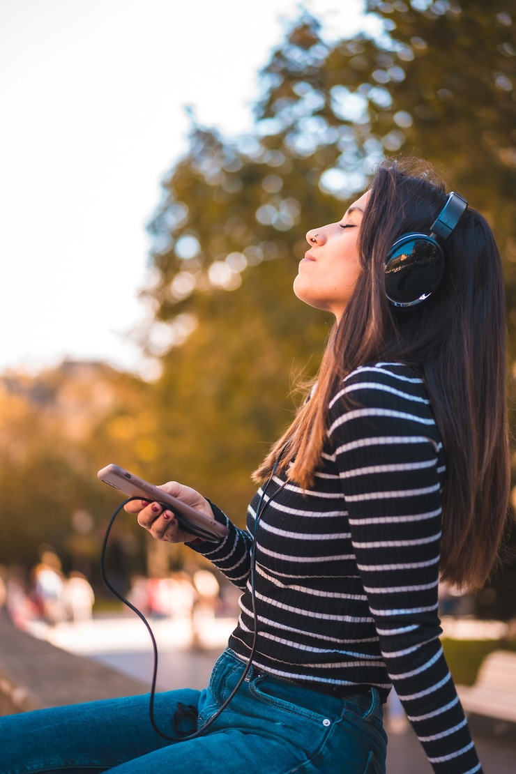 Foto portret vrouw luisteren muziek in park