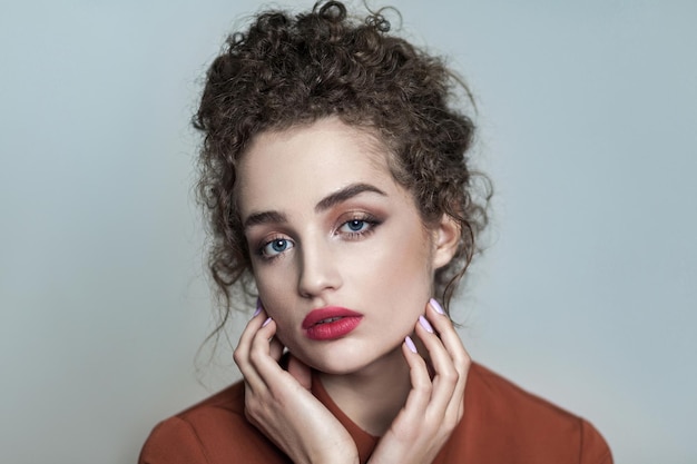 Portrit of beautiful young model with makeup and curly hair