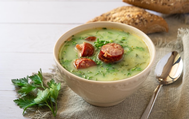 Portuguese Cabbage soup called Caldo Verde on white table