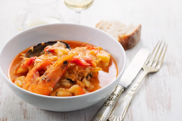 Portuguese fish and seafood stew in dish on ceramic surface