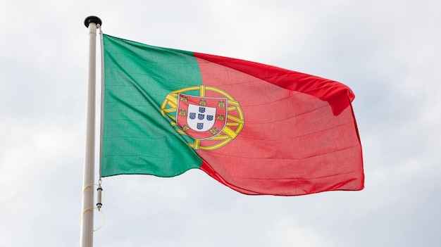 Portuguese flag waving against cloudy sky background