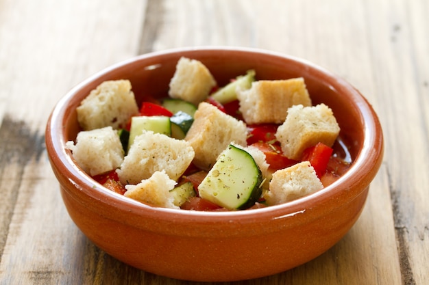 Portuguese gaspacho in bowl in brown wooden surface