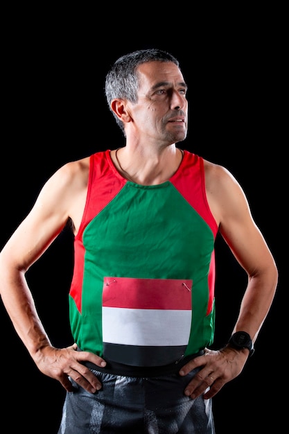 Portuguese runner man of middle age on a black background.