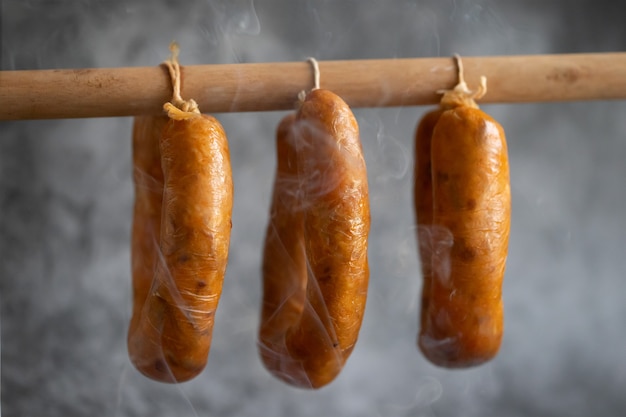 Portuguese smoked sausages alheira on wooden stick