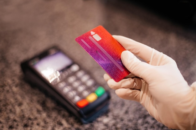 Pos terminal at cafe or restaurant counter Contactless payment method to keep social distancing while pandemic Closeup woman's hands