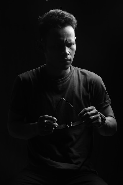 pose of a teenager on a black background, in a photo studio room