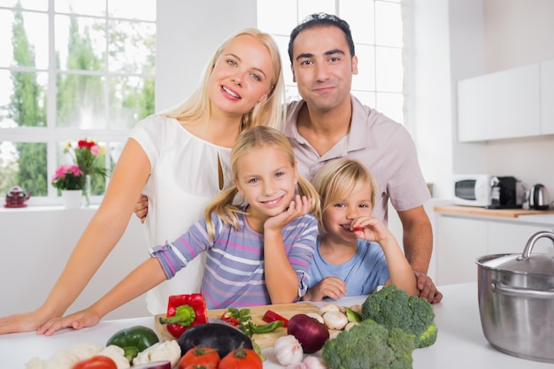 Posing family cutting vegetables