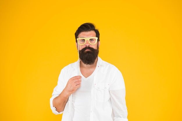 Posing for photo serious bearded man party glasses party accessory good mood ready for holiday smart nerd eyeglasses last minute costume party ideas how nerds have fun barbershop concept