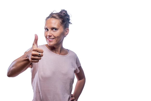 Positive adult woman showing thumb up on a white background