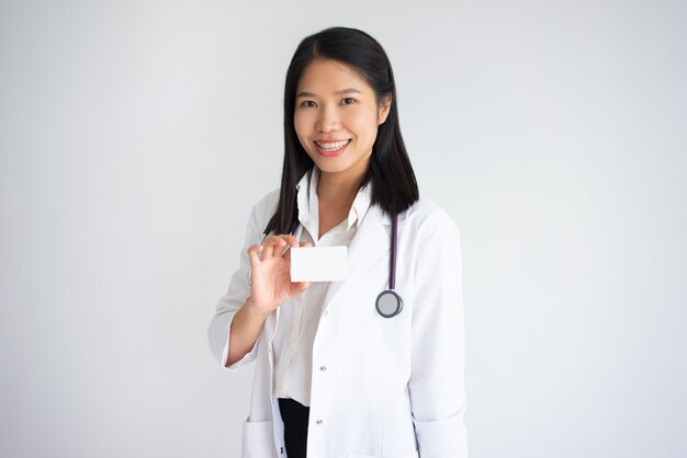 Positive Asian Female Doctor Showing Badge