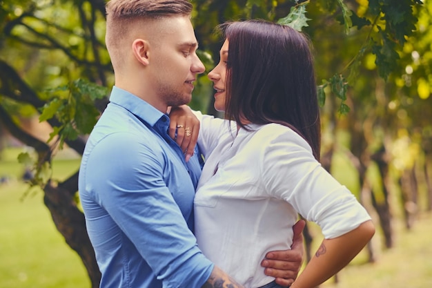 Positive attractive couple on a date in a city park.