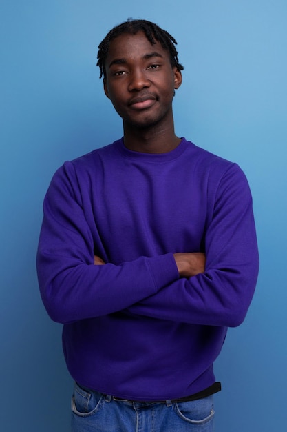 Positive black american young guy with dreadlocks smiling