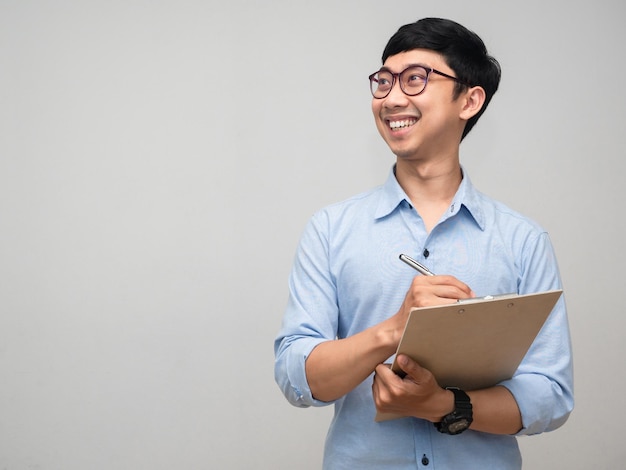 Positive businessman hold document board smile and looking at copy space