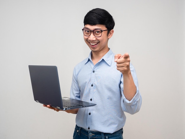 Positive businessman holding laptop gesture point finger to choose you isolated