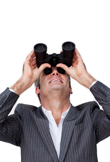 positive businessman looking up through a pair of binoculars 