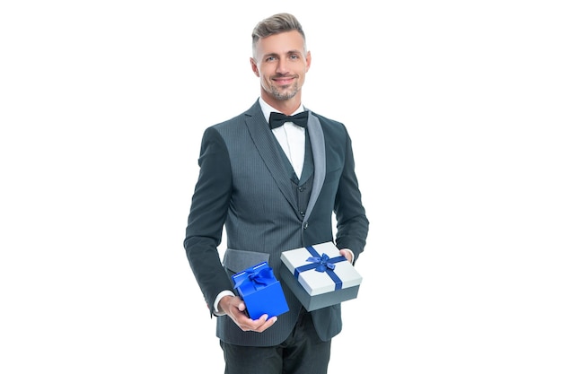 Positive businessman in tuxedo with box isolated on white boxing day