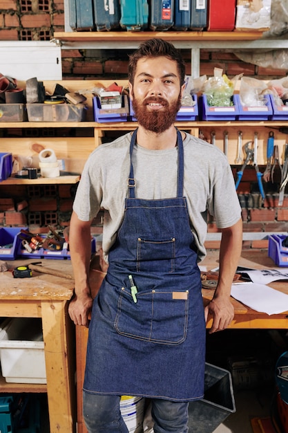 Positive carpenter in his workshop