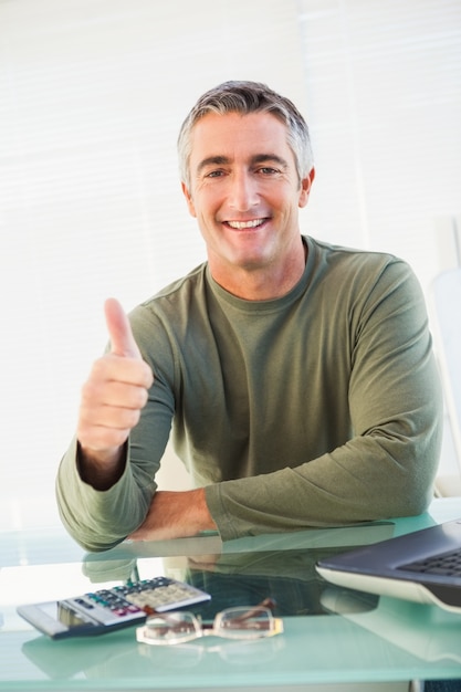 Positive casual man with his thumb up 