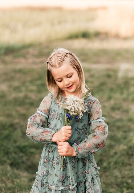 Positive charming little girl enjoying summer sunny day, expression emotions, having fun, happy child walking in summer day