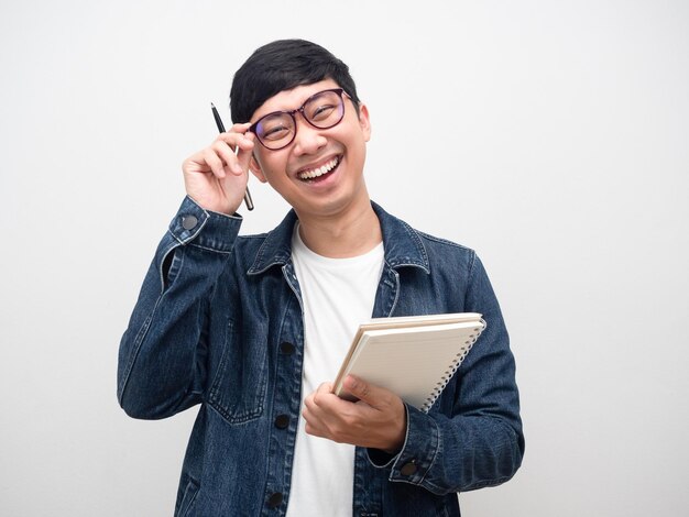 Positive cheerful man wearing glasses holding diary laugh isolated