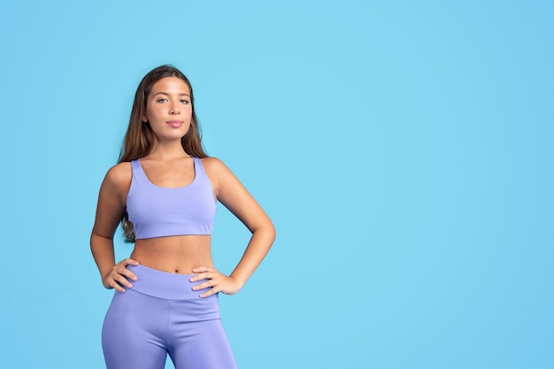 Positive confident millennial caucasian slim woman in sportswear look at camera