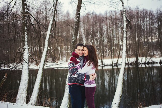 Positive couple on the background of the river