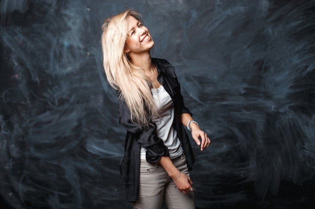 Positive cute cheerful girl with blond hair laughing