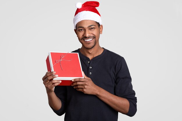 Positive dark skinned man with cheerful expression