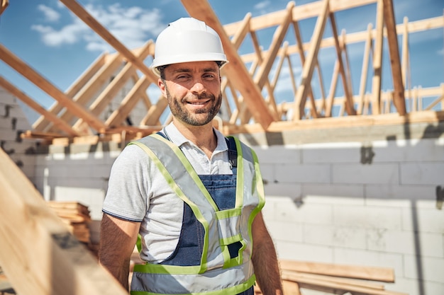 Positive delighted constructor looking straight at camera