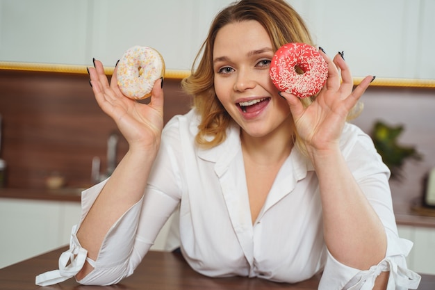 Positive delighted girl keeping smile on her face, posing a