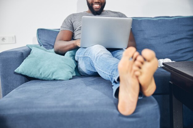 Positive delighted international man working on distance