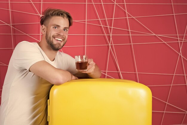 Photo positive delighted man standing in kitchen with coffee cup