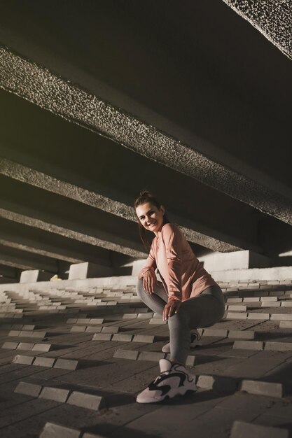 Positive fitness woman sits