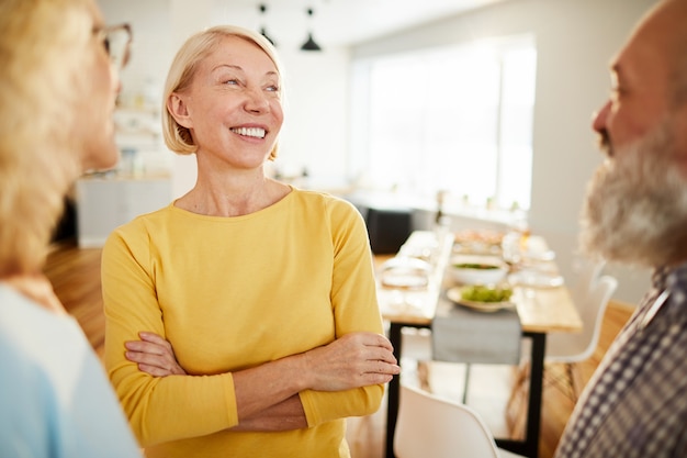 Positive friends chatting in dining room