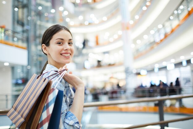 Positive girl with purchases