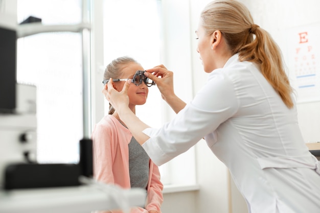 Positive good-looking child getting ready for measuring