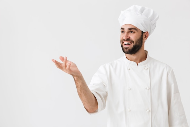 positive happy young chef posing in uniform.