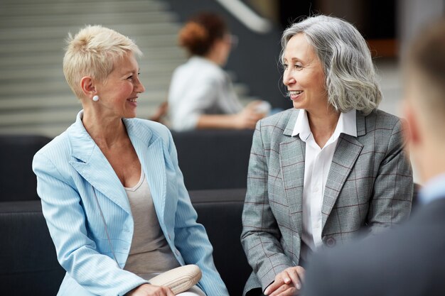 Positive ladies talking in lobby