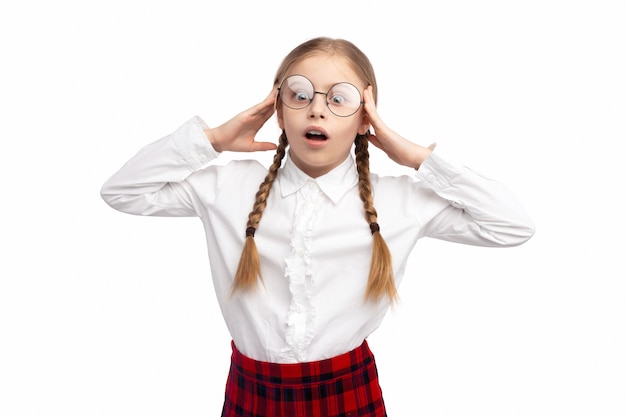 Positive little girl in school uniform