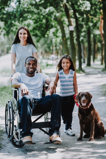 Positive Man in Wheelchair Young Woman and Girl