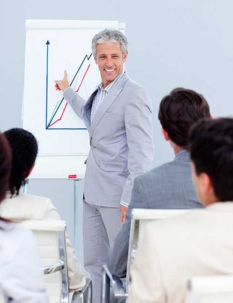 Positive mature businessman doing a presentation