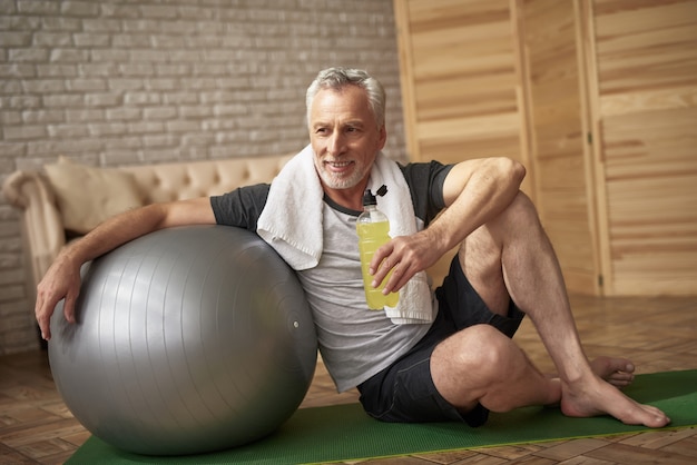 Positive Pensioner Drinks Water after Workout.