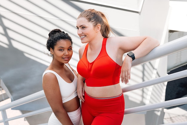 Positive plussize women relaxing during workout outdoors