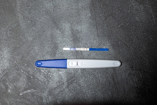 Positive pregnancy test on gray surface