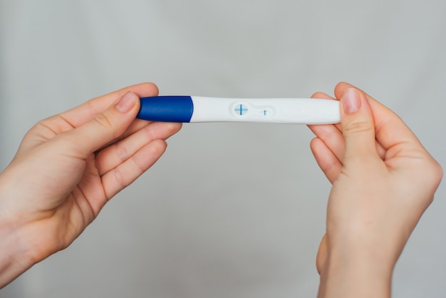 Positive pregnancy test in the hands of a girl