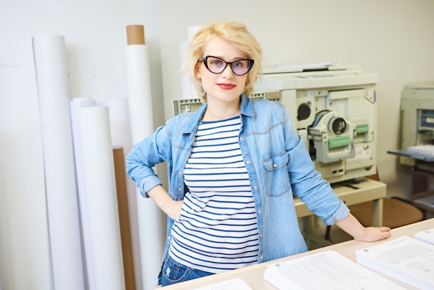 Positive printer operator looking at camera