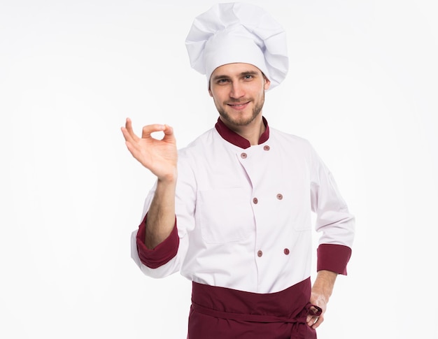 Positive professional happy man chef showing tasty ok sign isolated on white background.